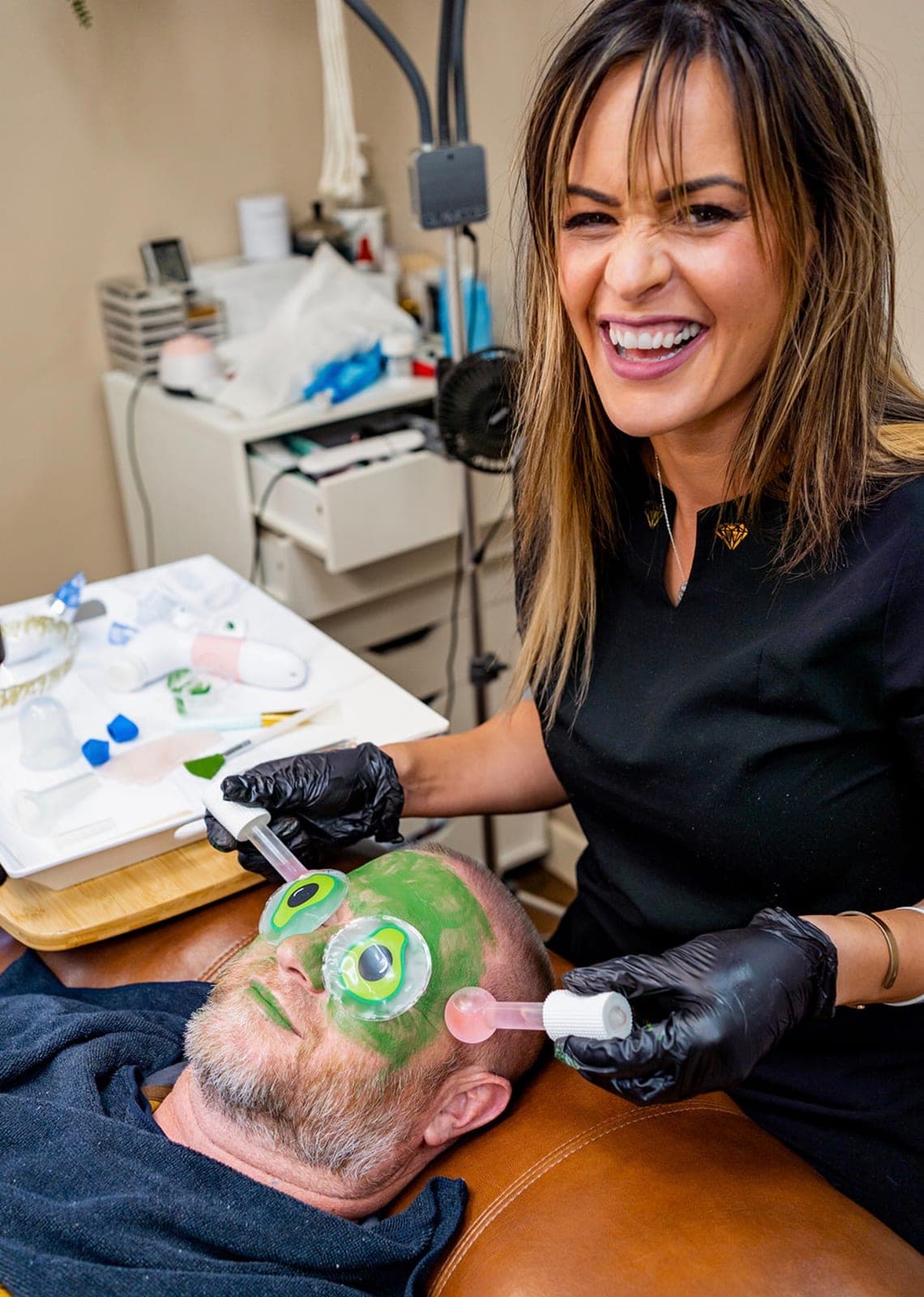 Alisa performing a facial treatment on a client